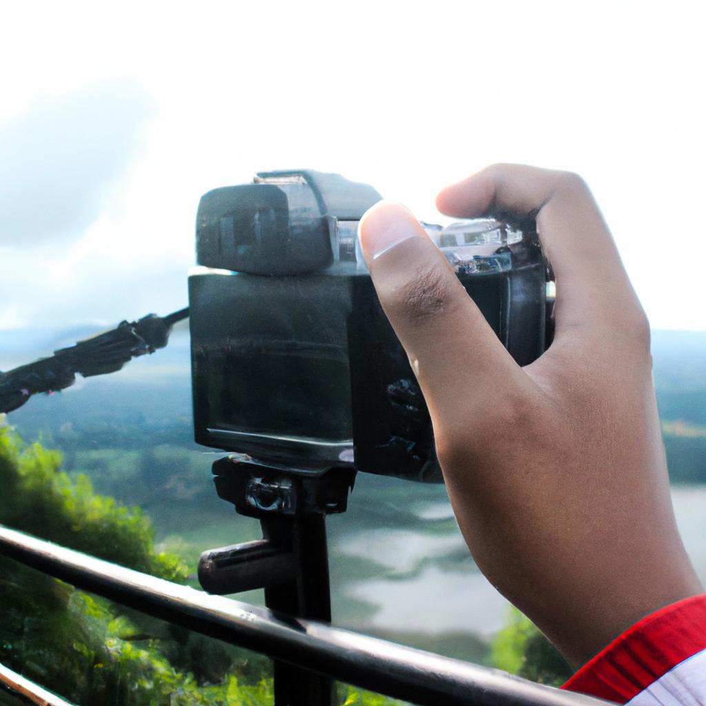 Person holding camera, capturing landscape